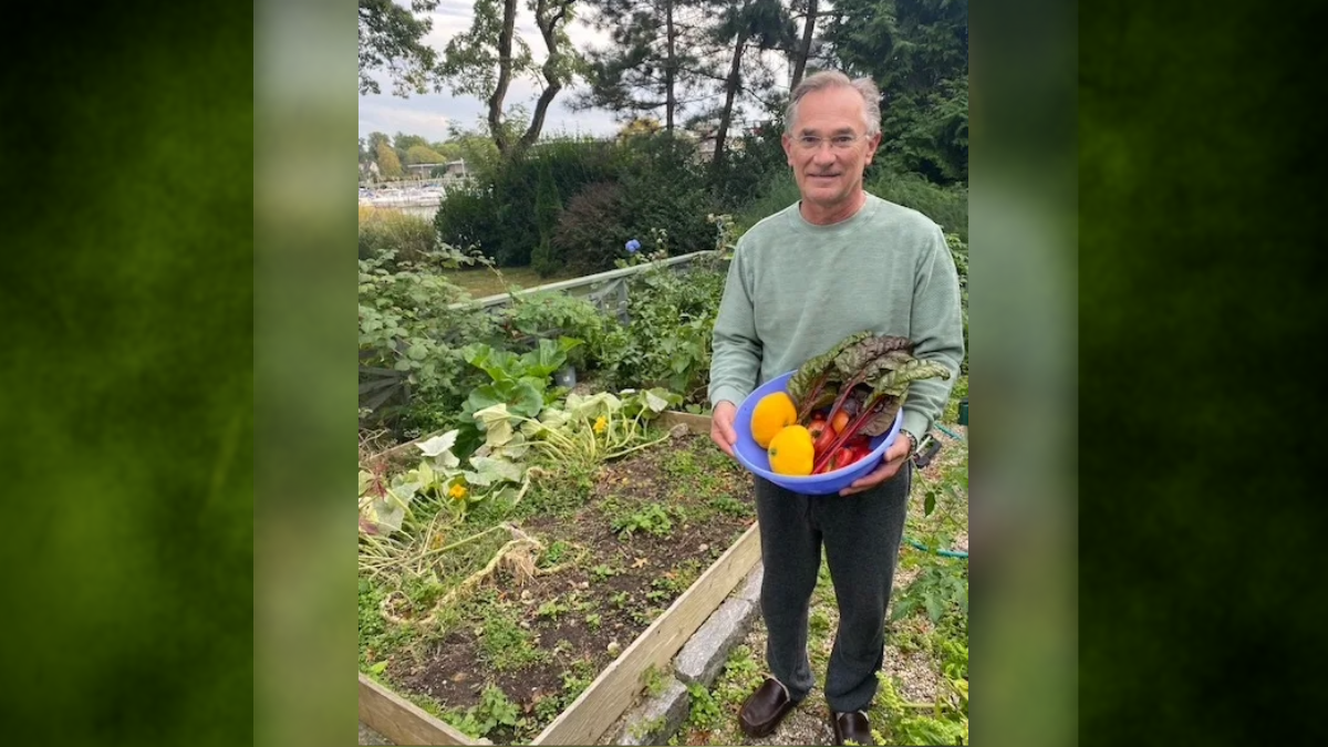 Dr Chabot stands in his garden with harvest.